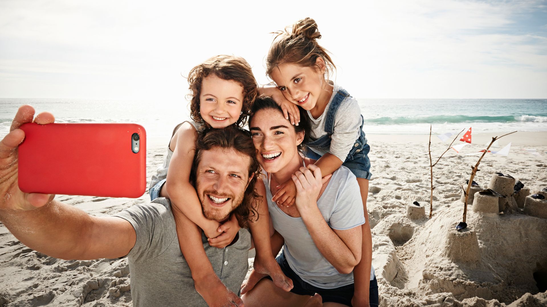 familia haciéndose un selfie en la playa