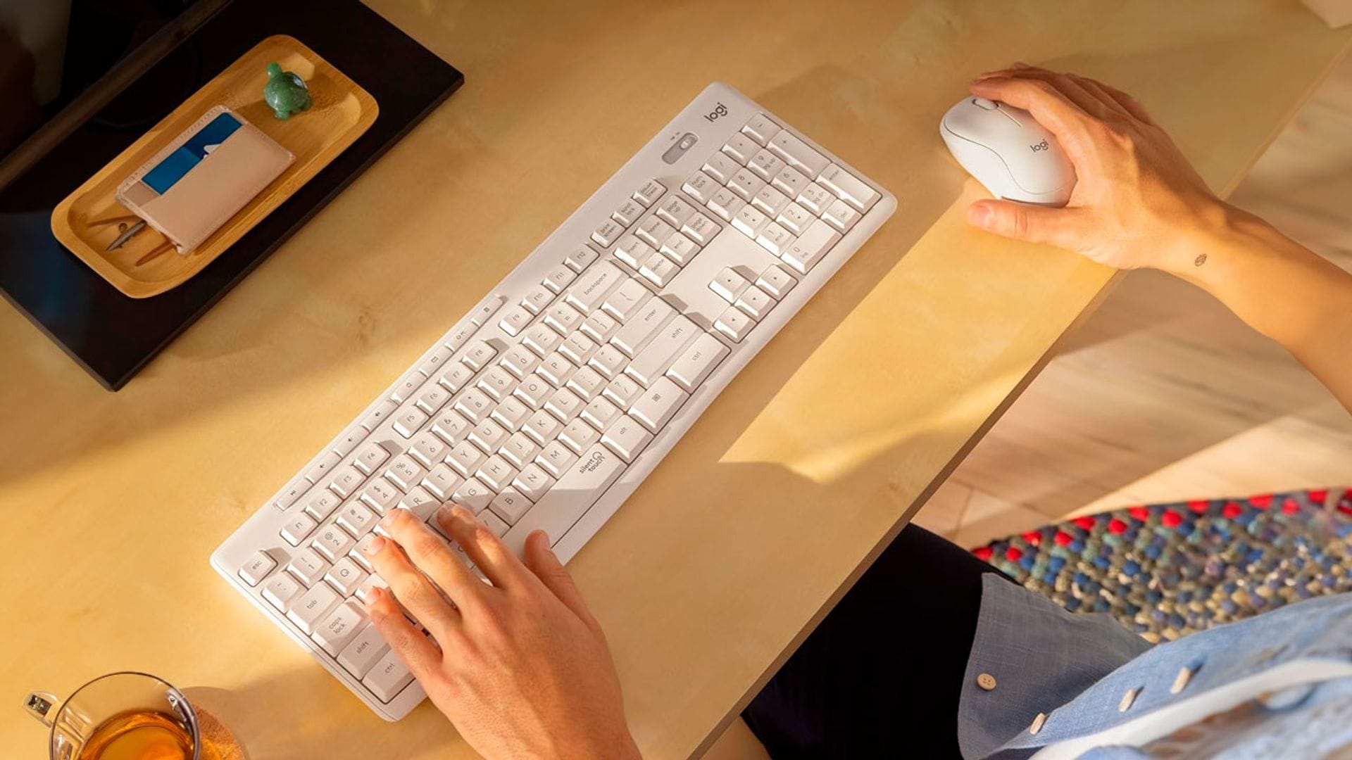 Una persona usando un teclado y un ratón Logitech 