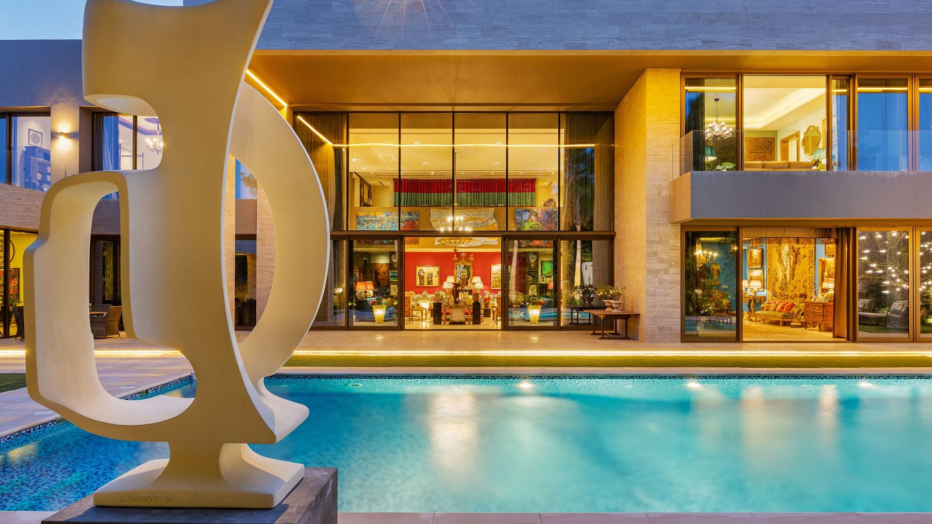 La fachada y la piscina, desde la que se vislumbra el salón principal, que destaca por sus paredes de doble altura