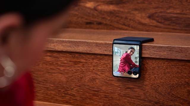 Una chica haciéndose una foto con un teléfono plegable