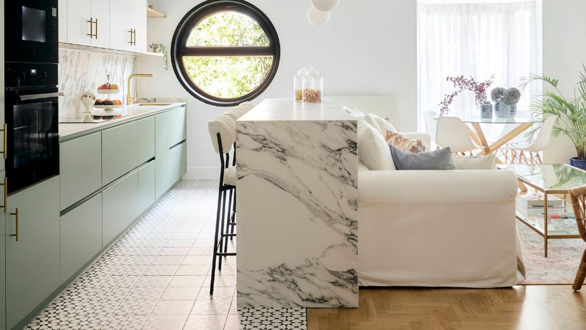 Cocina con muebles verdes abierta al salón