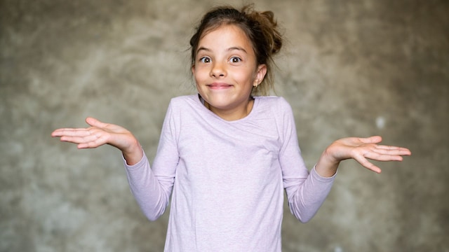 Niña con gesto de no saber algo