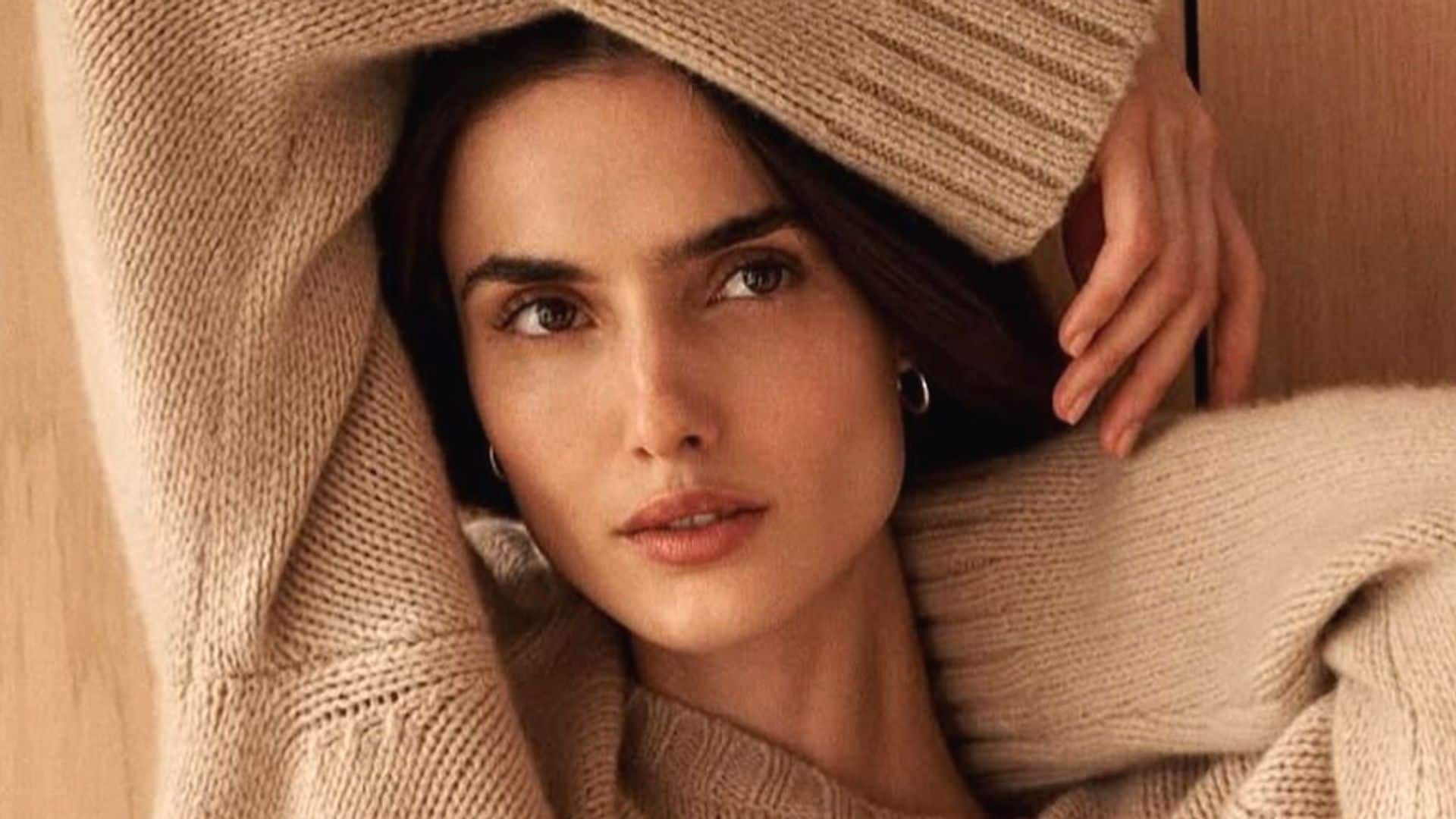 Blanca Padilla con jersey beige oversized y las manos en la cara