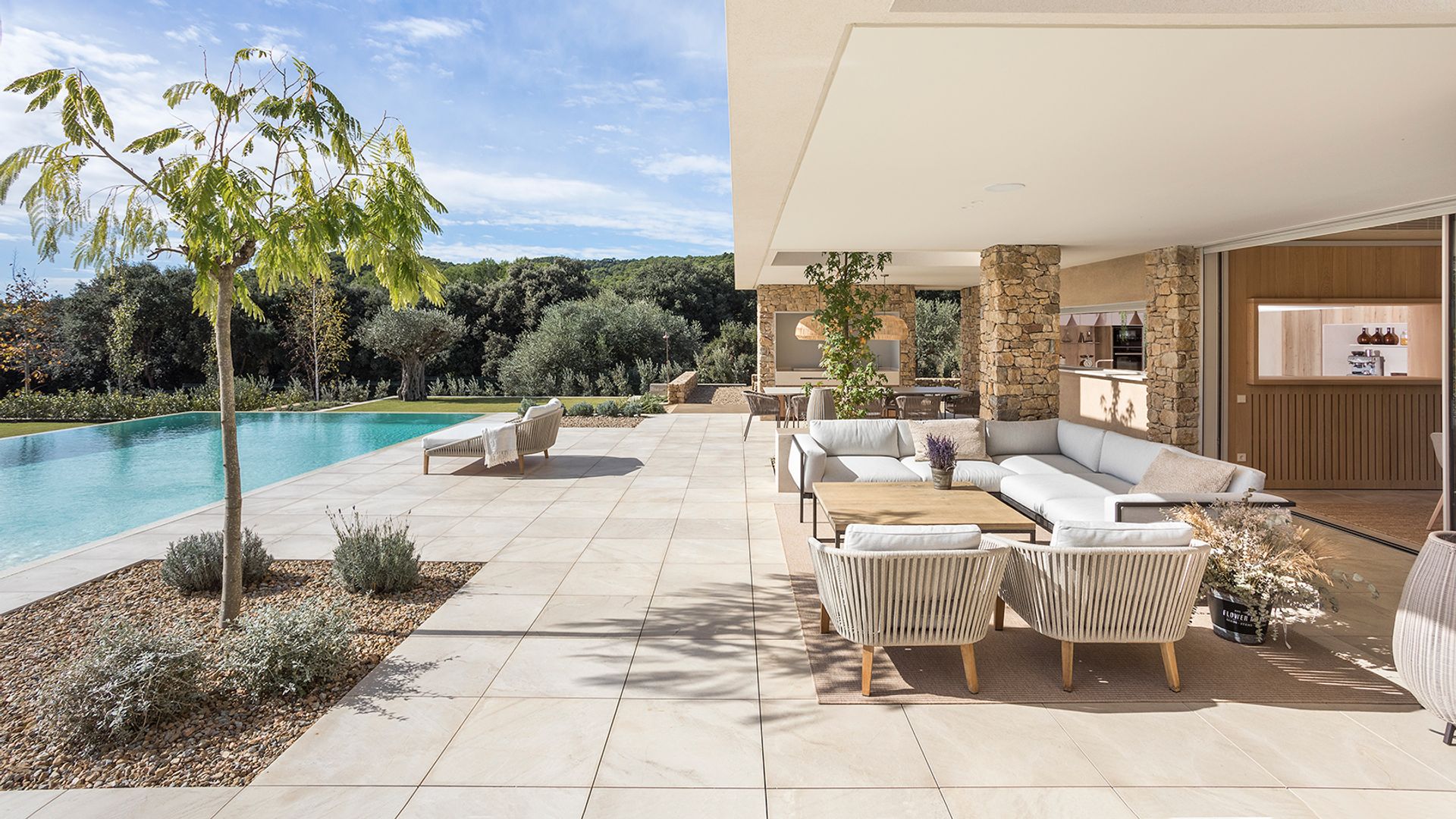 Casa con piscina, con porche con salón exterior con muebles blancos, suelo cerámico