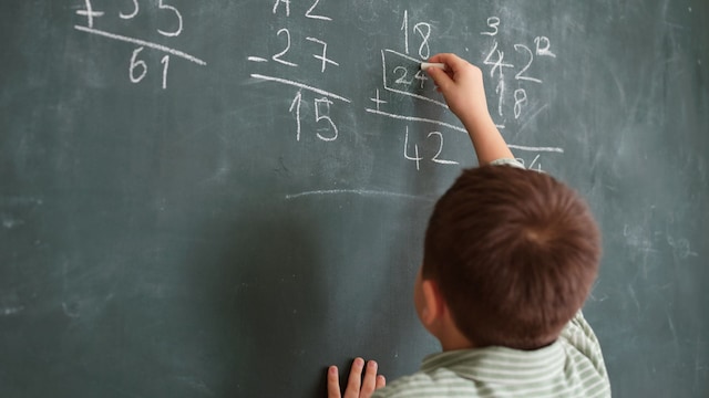 Niño suma en la pizarra