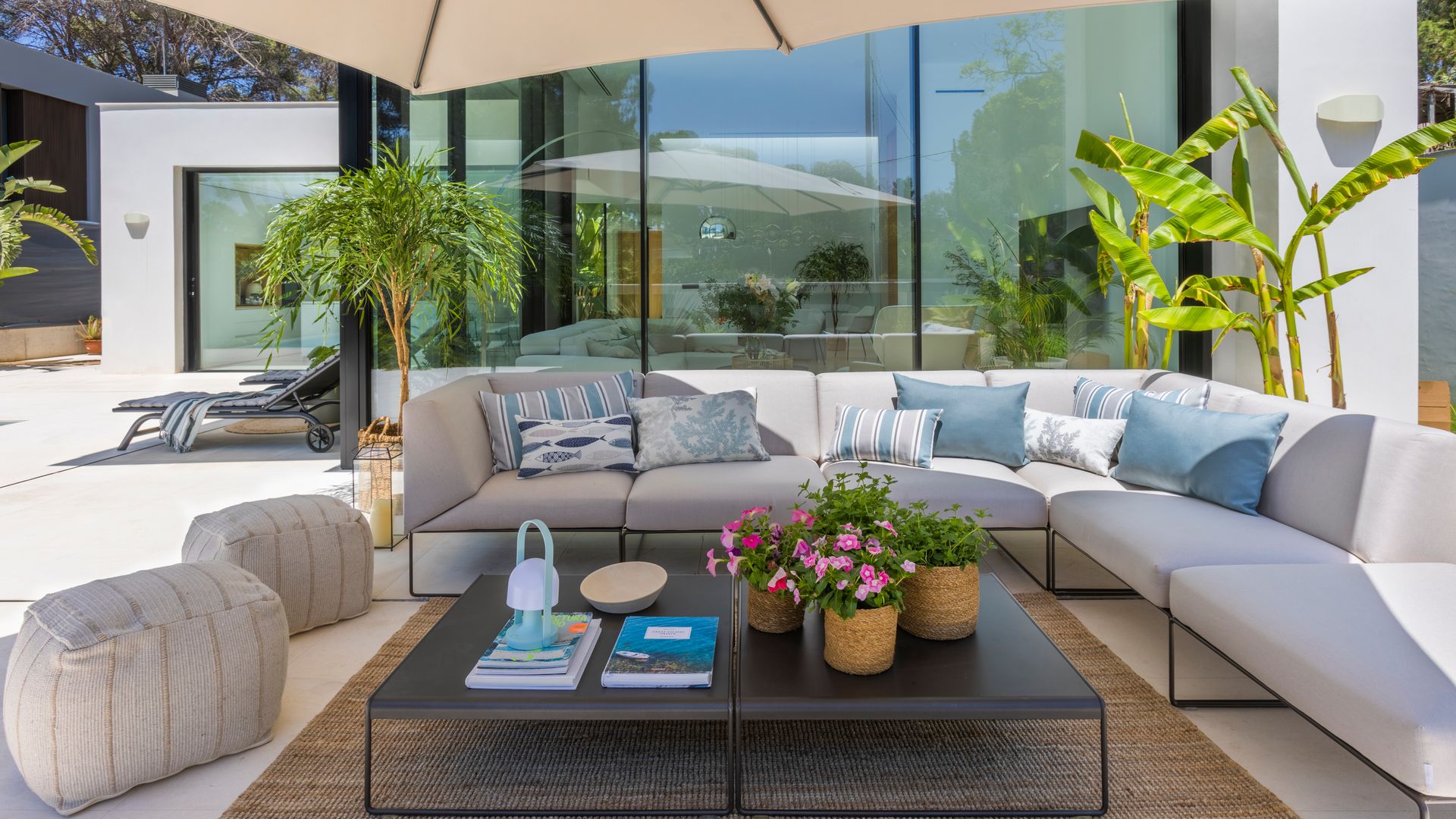 Porche exterior bajo sombrilla, en un proyecto de Majo Flores Interiorismo