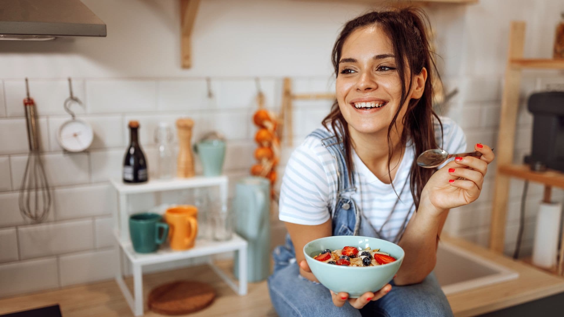 Mujer tomando fruta para el desayuno