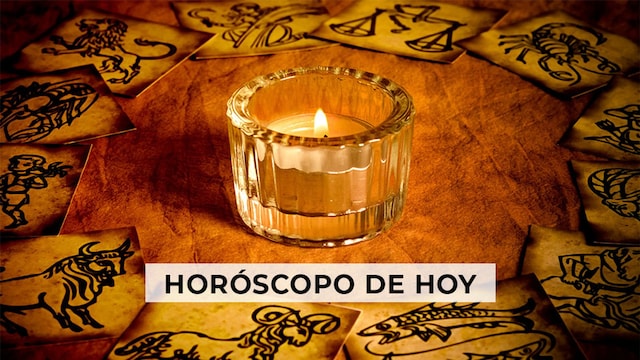 Cartulinas con el símbolo del signo del zodiaco, dispuestas en círculo; en medio una vela encendida
