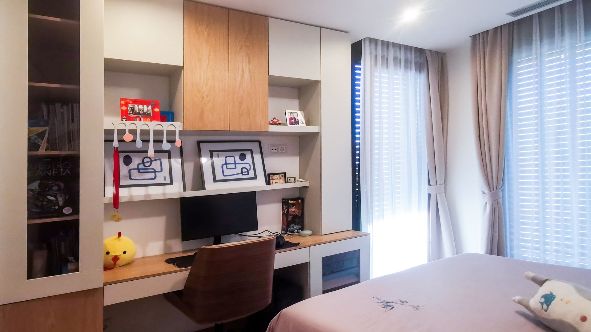 Zona de escritorio con mueble a medida, cortinas, plafones en el techo y baldas