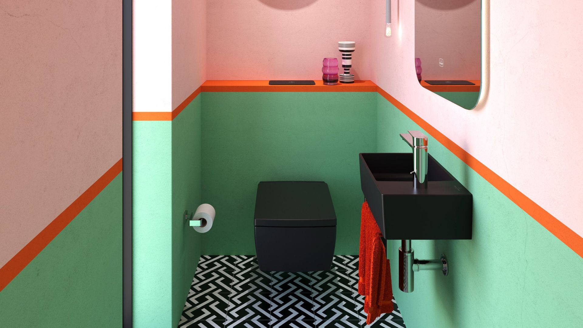 Aseo de cortesía con paredes en rosa claro, zócalo de pintura verde, lavabo y sanitario negros, espejo, suelo en blanco y negro