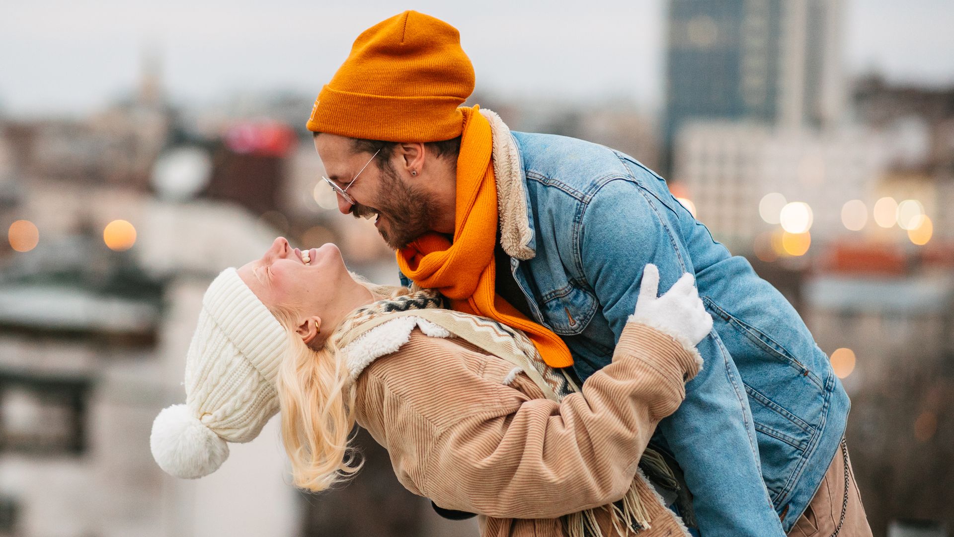Una pareja joven en invierno riendo al aire libre