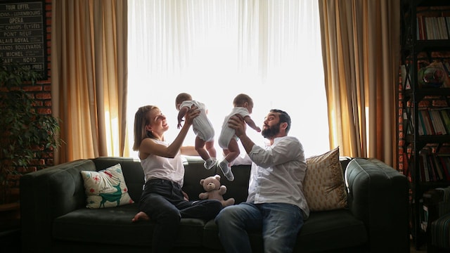 playing parents and twin babies in bedroom