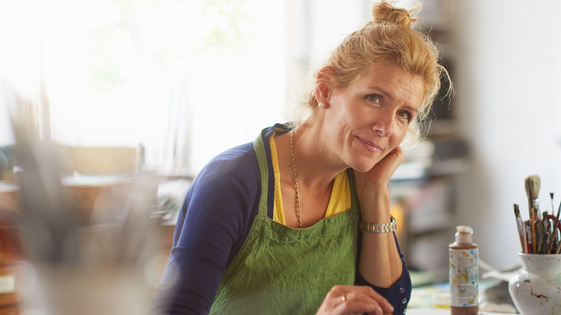 Retrato de una mujer madura pintando en su casa