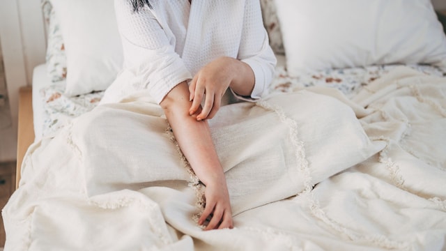 Sensitive skin allergic concept, Woman itching on her arm have a red rash from allergy symptom and from scratching.