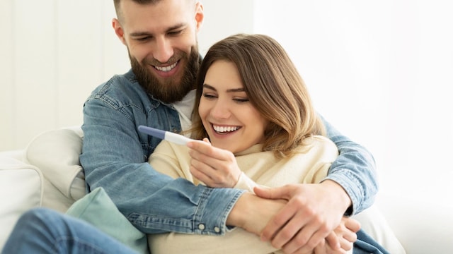pareja con test de embarazo positivo