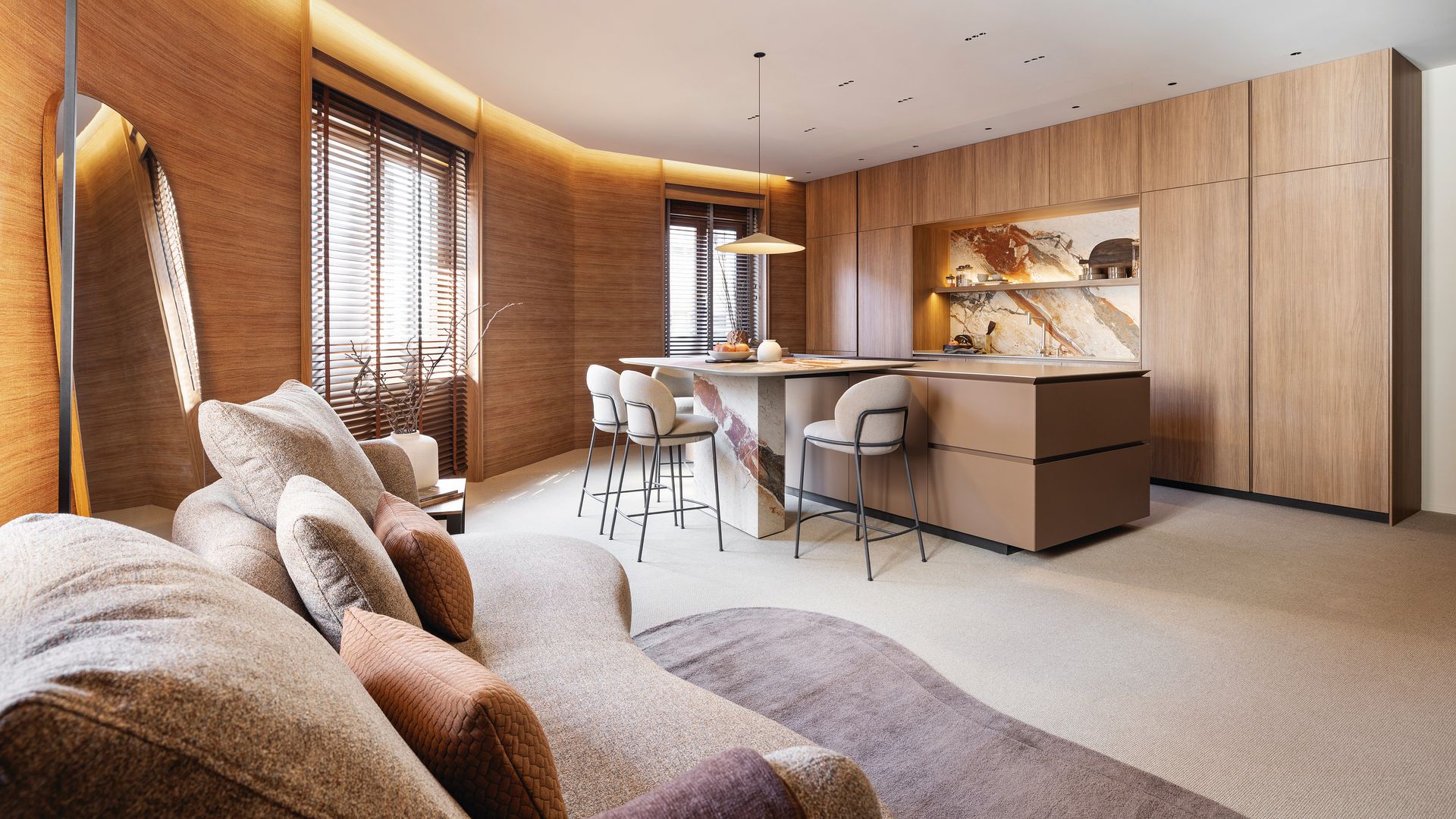 Cocina que integra una zona de estar, el ‘office’ adosado a la isla y una zona de bar escamoteada en el mueble principal 