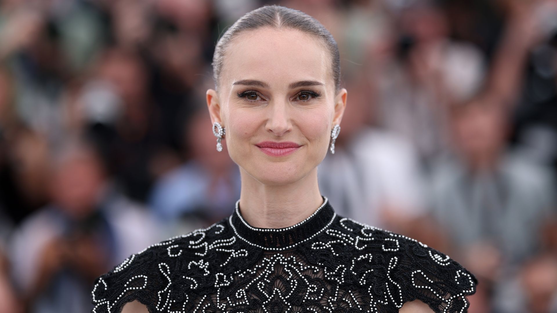 Natalie Portman en el Festival de cine de Cannes 2025 con vestido negro bordado, recogido y maquillaje natural