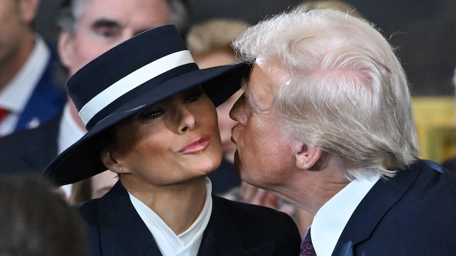 US President-elect Donald Trump kisses Melania Trump as he arrives for the inauguration ceremony before he is sworn in as the 47th US President in the US Capitol Rotunda in Washington, DC, on January 20, 2025. (Photo by SAUL LOEB / POOL / AFP) (Photo by SAUL LOEB/POOL/AFP via Getty Images)