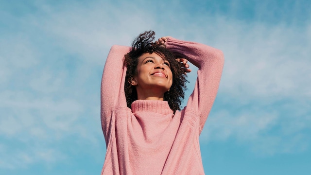 portrait of happy young woman enjoying sunlight