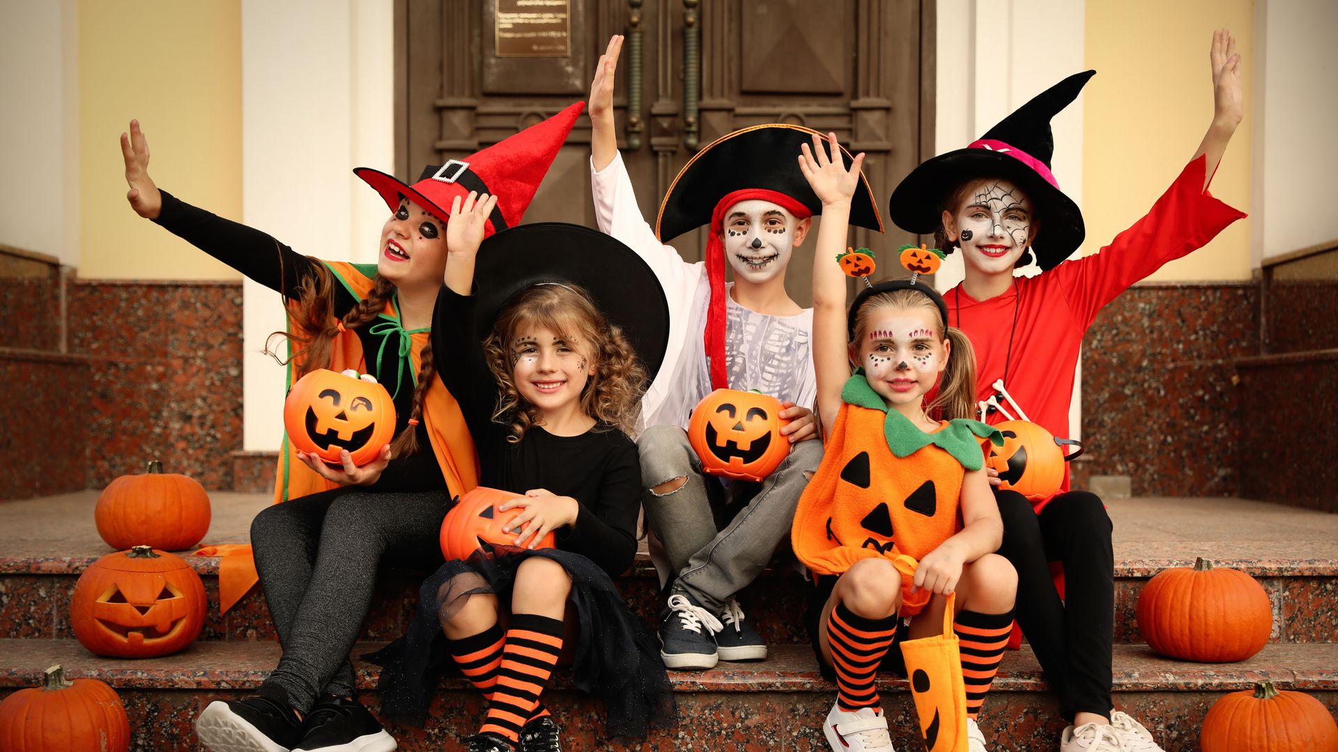 Niños disfrazados por Halloween en la puerta de una casa