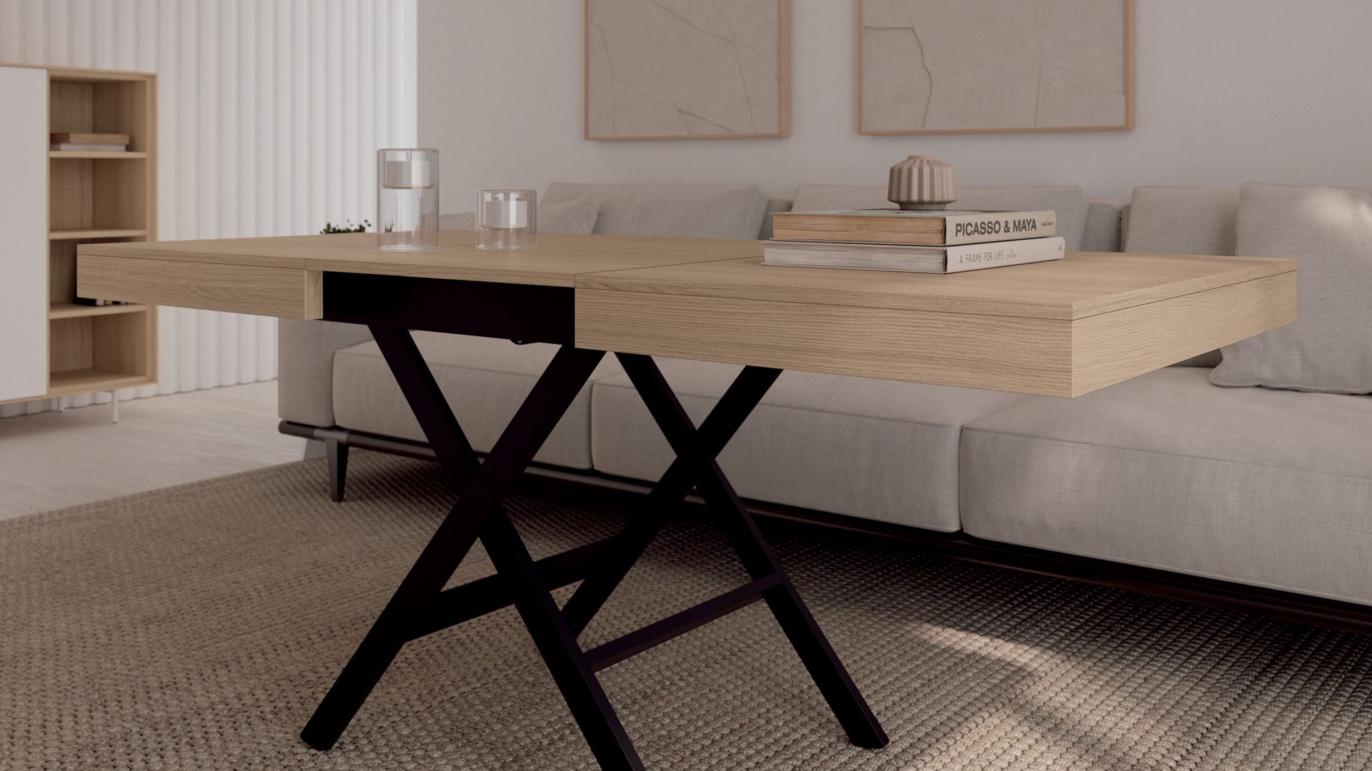 Salón con mesa de centro elevable en madera y patas metálicas negras, sofá beige, cuadros en la pared del sofá 