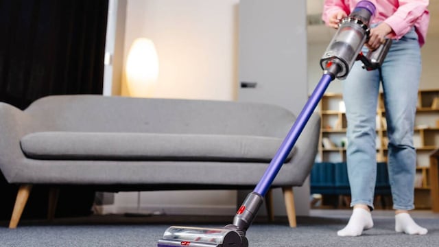 Una chica utilizando una aspiradora Dyson