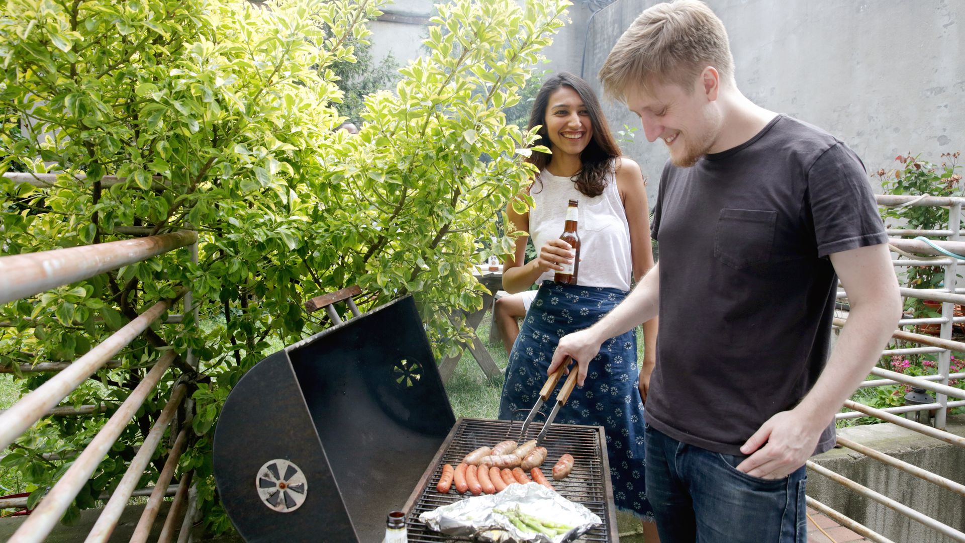 amigos haciendo una barbacoa en una terraza
