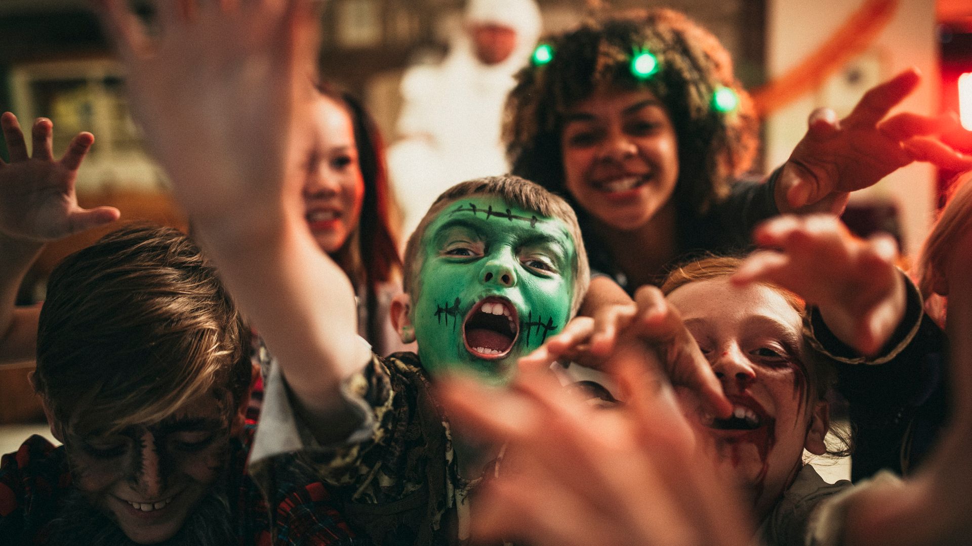 Niños disfrazados de Halloween, todos jugando y maquillaje.