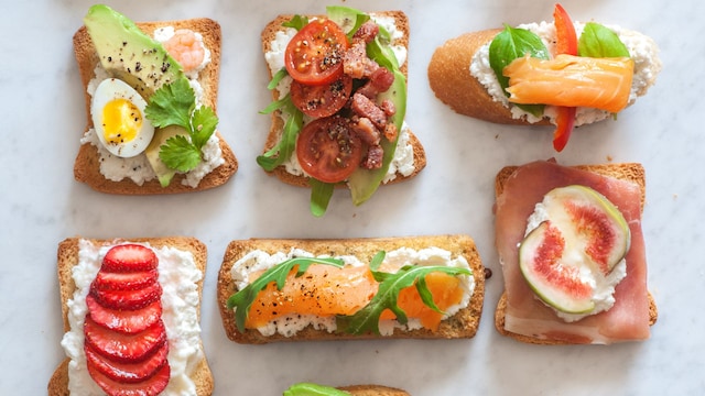 An assortment of tartines, small open-faced sandwiches with various toppings both savory and sweet.