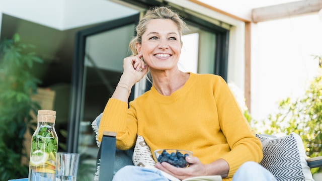 Portrait of happy mature woman relaxing on terrace