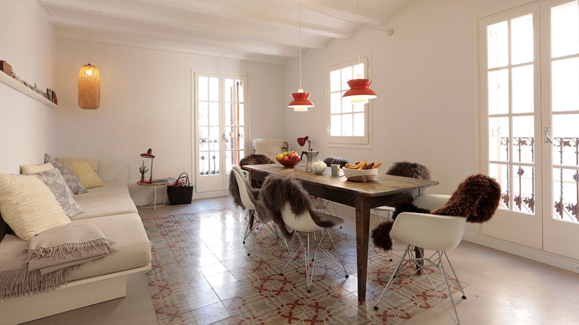 Salón comedor con suelo hidráulico, pieles sobre las sillas, lámparas de techo