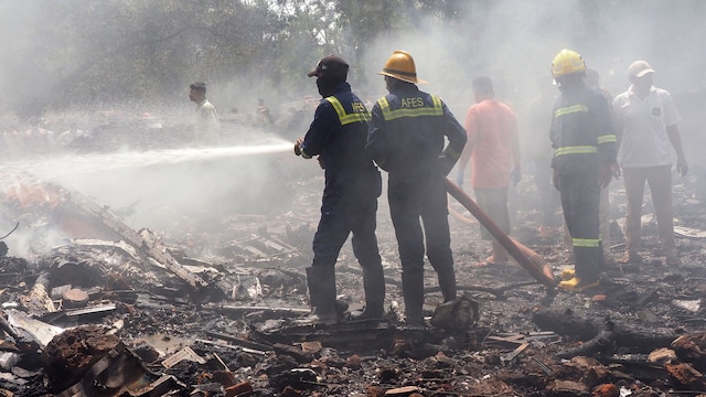 Firefighters work at the site where Air India flight 171 crashed in a residential area near the airport in Ahmedabad on June 12, 2025. The London-bound passenger plane crashed on June 12 in India's western city of Ahmedabad with 242 on board, aviation officials said in what the airline called a "tragic accident". (Photo by Sam PANTHAKY / AFP) (Photo by SAM PANTHAKY/AFP via Getty Images)
