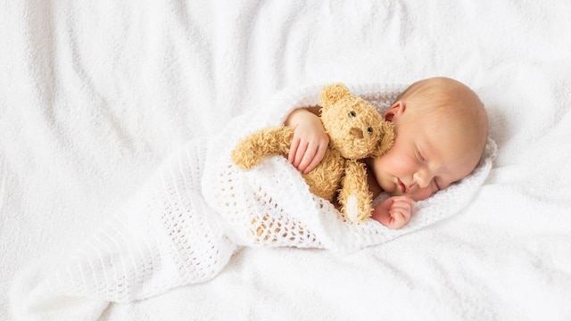 newborn baby with teddy bear