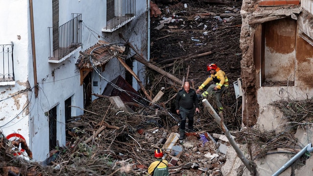 Members of the emergency services work in a devastated street on October 30, 2024 after flash floods ravaged the town of Letur, southwest of Valencia, eastern Spain. Rescuers raced on October 31, 2024 to find survivors and victims of once-in-a-generation floods in Spain that killed at least 95 people and left towns submerged in a muddy deluge with overturned cars scattered in the streets. About 1,000 troops joined police and firefighters in the grim search for bodies in the Valencia region as Spain started three days of mourning. Up to a year's rain fell in a few hours on the eastern city of Valencia and surrounding region on October 29 sending torrents of water and mud through towns and cities. (Photo by OSCAR DEL POZO / AFP) (Photo by OSCAR DEL POZO/AFP via Getty Images)