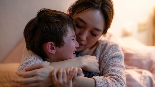 Madre abraza y consuela a su hijo, que está llorando