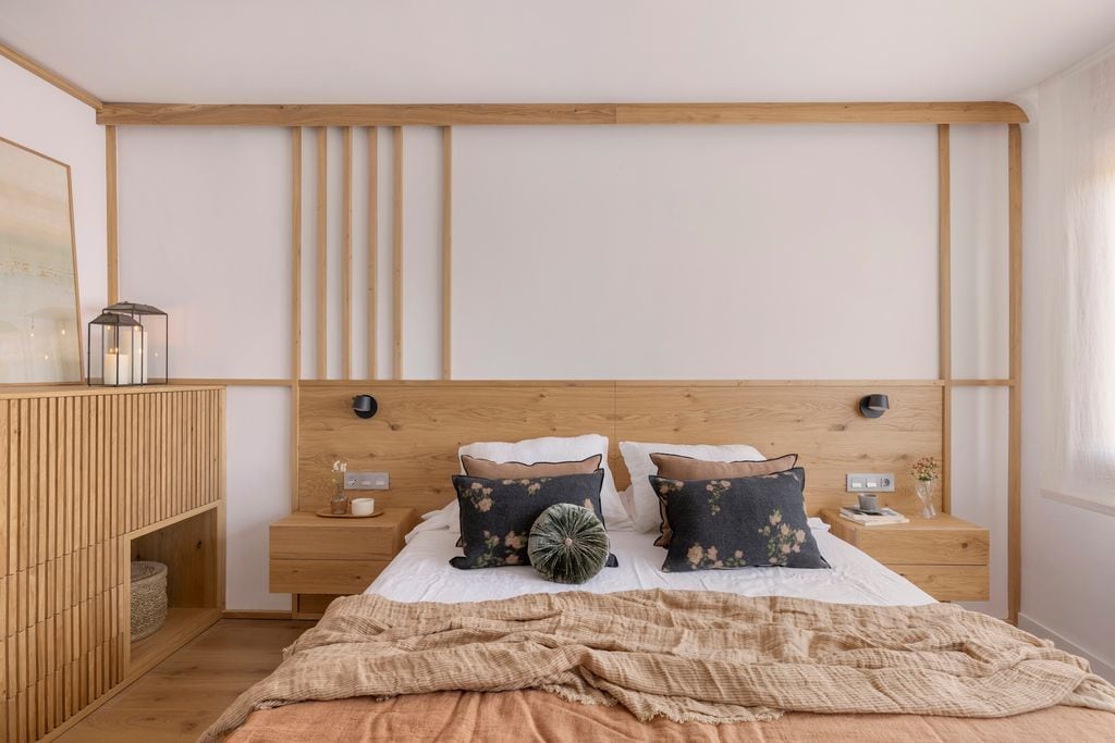 Dormitorio con cabecero con listones de madera.