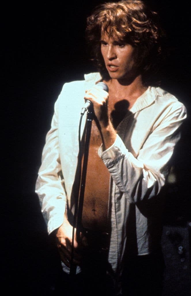 Val Kilmer at the microphone in a scene from the film 'The Doors', 1991. (Photo by Carolco/Getty Images)