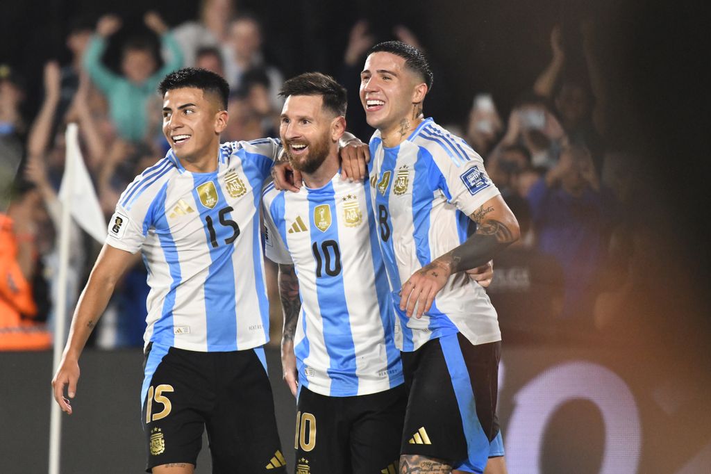 Lionel Messi of Argentina celebrates his third goal of the night with Thiago Almada and Enzo Fernandez during a match between Argentina and Bolivia at Estadio Mas Monumental Antonio Vespucio Liberti in Buenos Aires, Argentina, on October 15. (Photo by Federico Peretti/NurPhoto via Getty Images)