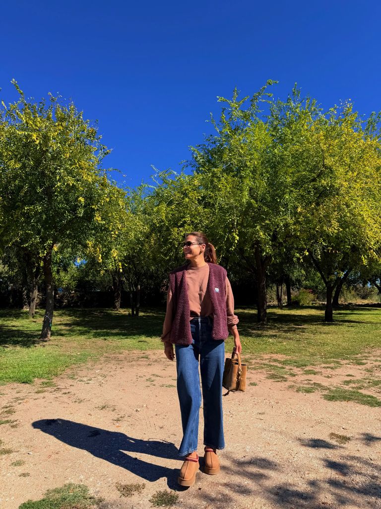 Nuria Roca en el campo con sudadera, chaleco de borrego y sus zuecos de UGG