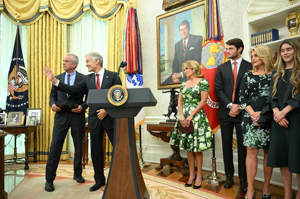 Oz habla con Robert F. Kennedy bajo la atenta mirada de los familiares del doctor  
