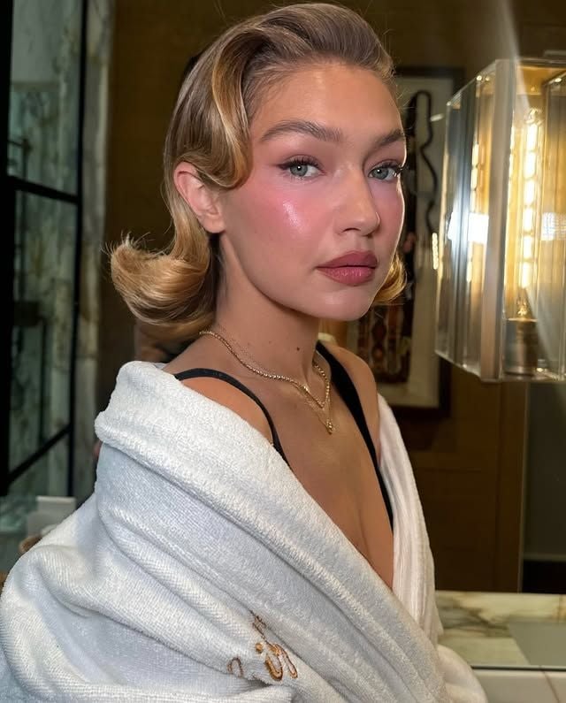 Gigi Hadid con albornoz blanco maquillada por Patrick Ta