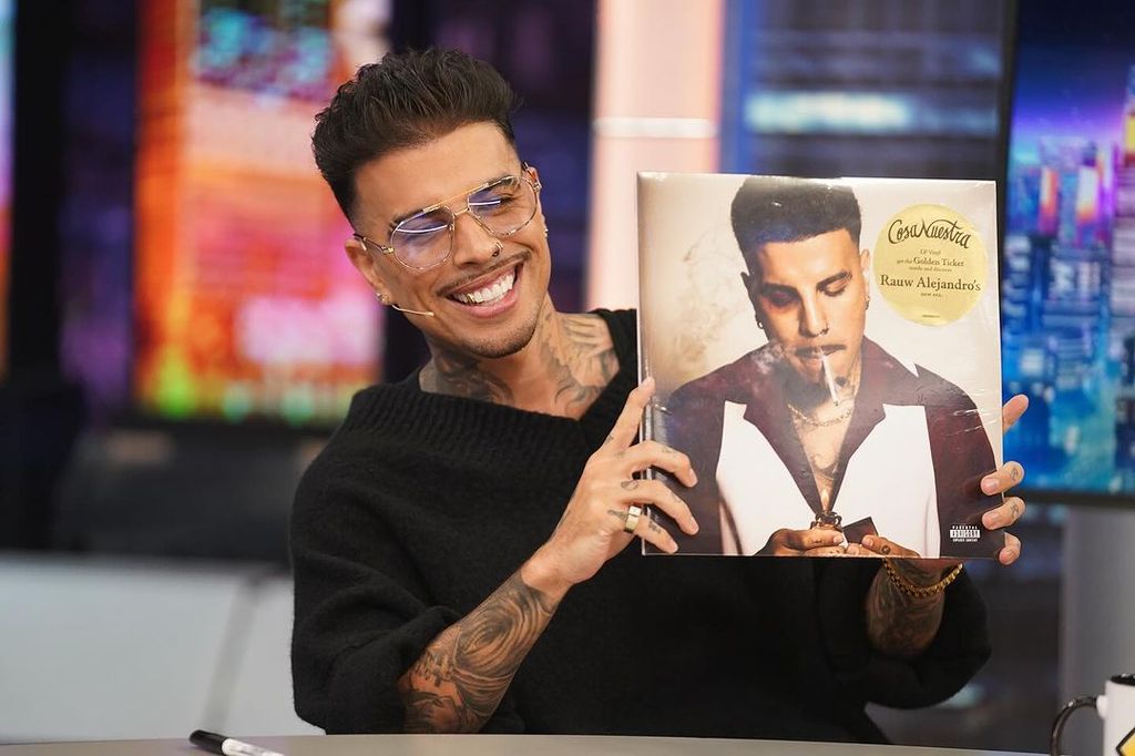 Plano medio de Rauw Alejandro en El Hormiguero enseñando la portada de su álbum