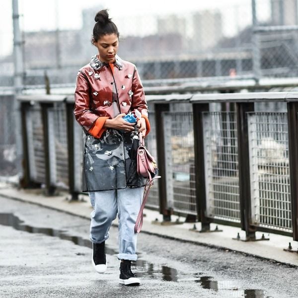 'LOOK' ANTILLUVIA: impermeable transparente + vaqueros remangados + bolso de correa.
