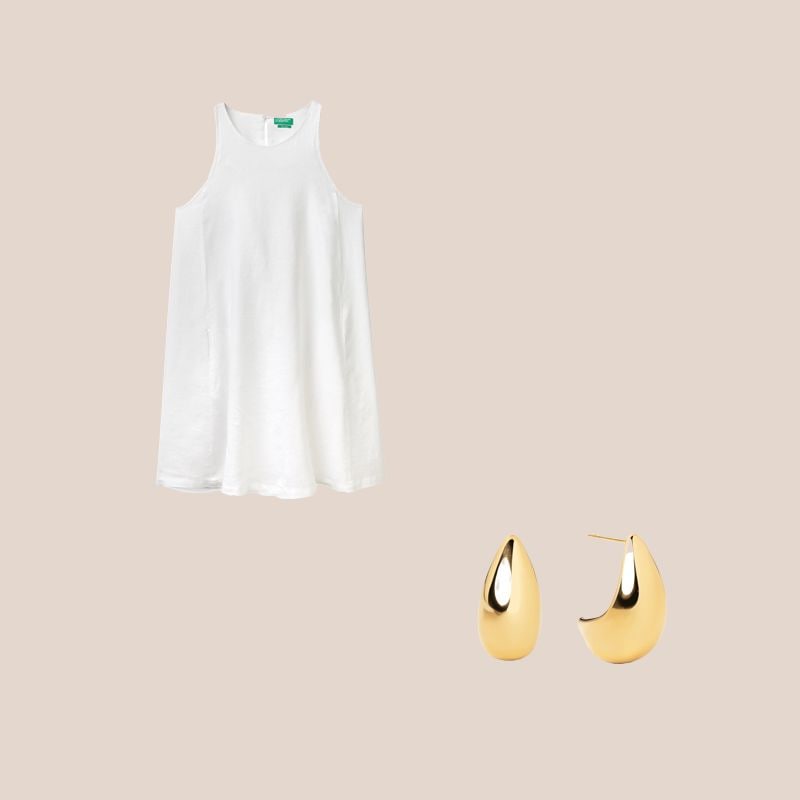 vestido blanco y pendientes dorados