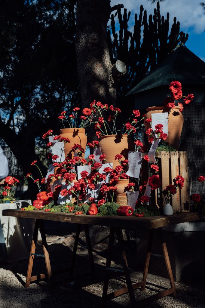 Seating plan con claveles rojos, gerberas y pimientos