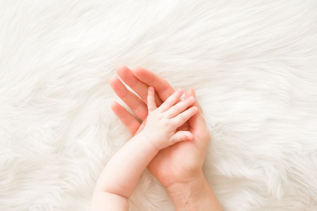 Mano de la madre y de su bebé