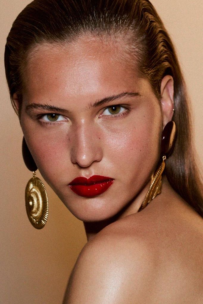 Modelo de Zara con pendientes de conchas y labios rojos