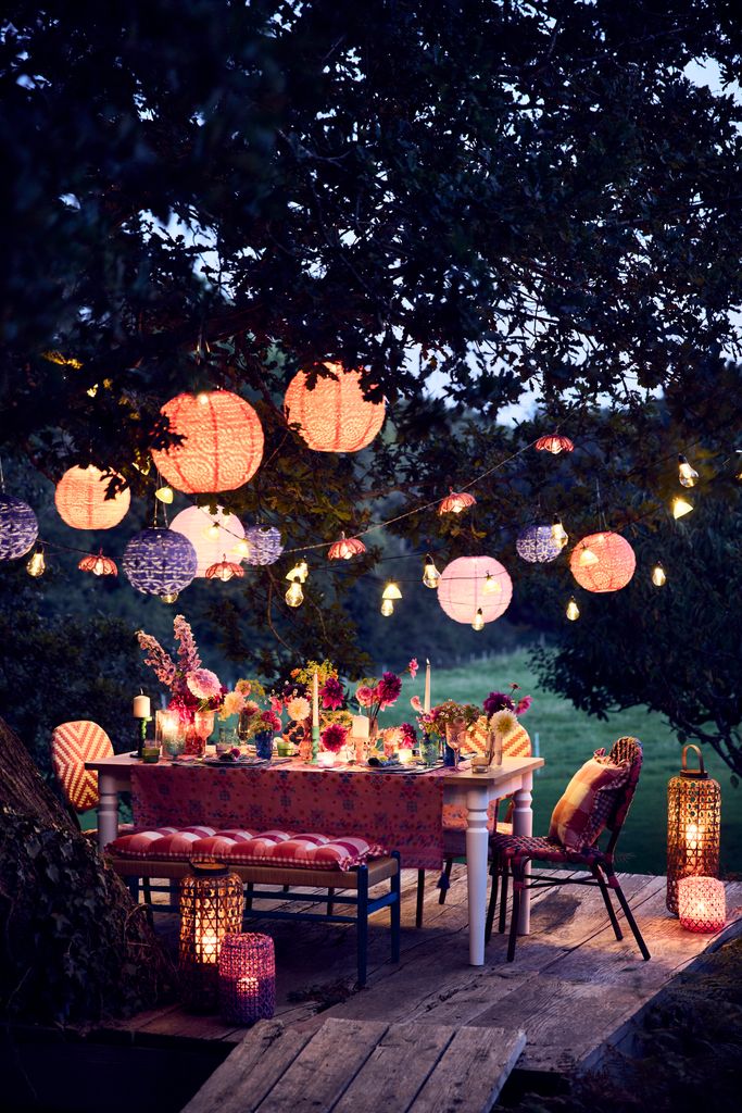 Comedor de verano iluminado con farolillos de papel