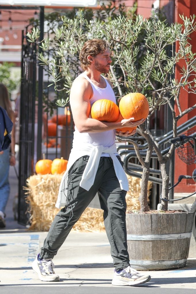 Christopher lució una playera blanca de tirantes que dejó al descubierto sus brazos marcados