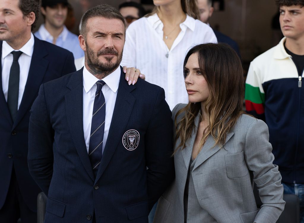 David Beckham is pictured with his wife Victoria Beckham during the national anthem before the game against Vancouver Whitecaps FC at Chase Stadium